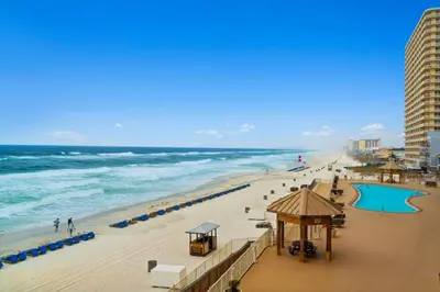 a view of a beach with the ocean and buildings at Treasure Island #0303 in Panama City Beach