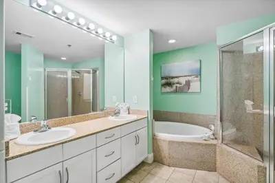 a bathroom with two sinks and a shower and a tub at Laketown Wharf #1825 in Panama City Beach