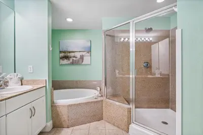 a bathroom with a shower and a tub and a sink at Laketown Wharf #1825 in Panama City Beach