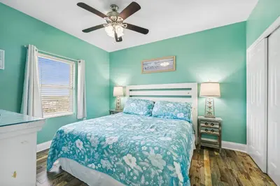 a bedroom with a bed and a ceiling fan at Laketown Wharf #1825 in Panama City Beach