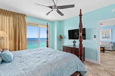 a bedroom with a bed with a view of the ocean at Treasure Island #1506 in Panama City Beach