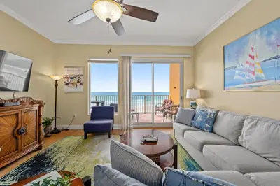 a living room with a couch and a tv at Treasure Island #0310 in Panama City Beach