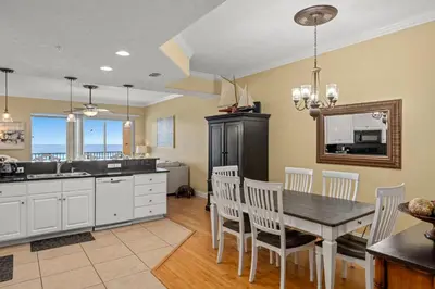 a kitchen and dining room with a table and chairs at Treasure Island #0310 in Panama City Beach