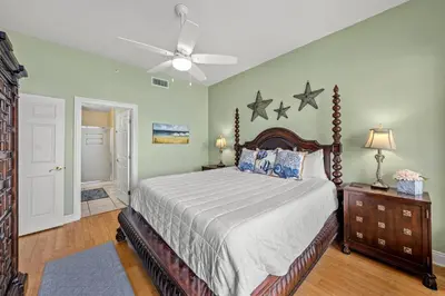 a bedroom with a bed and a ceiling fan at Treasure Island #0310 in Panama City Beach