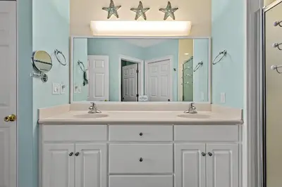 a bathroom with two sinks and a large mirror at Treasure Island #0310 in Panama City Beach