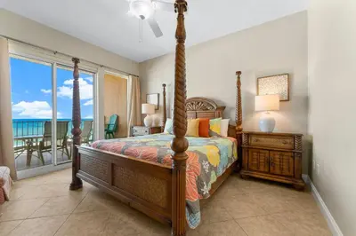 a bedroom with a bed with a view of the ocean at Treasure Island #0507 in Panama City Beach