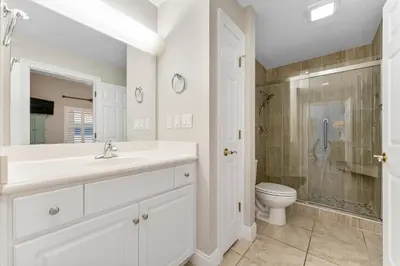 a white bathroom with a sink and a toilet at Treasure Island #0507 in Panama City Beach