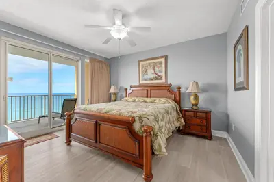 a bedroom with a bed and a view of the ocean at Treasure Island #1807 in Panama City Beach