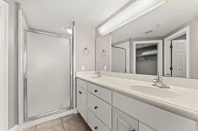 a white bathroom with a sink and a shower at Treasure Island #1807 in Panama City Beach