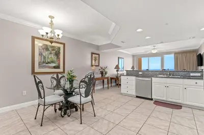 a kitchen with a table and chairs and a dining room at Treasure Island #1807 in Panama City Beach