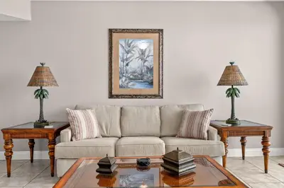a living room with a couch and two tables at Treasure Island #1807 in Panama City Beach