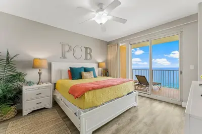 a bedroom with a bed with a view of the ocean at Treasure Island #2306 in Panama City Beach
