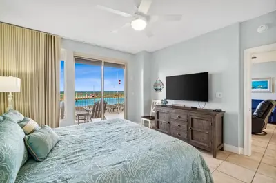 a bedroom with a bed and a flat screen tv at Treasure Island #0110 in Panama City Beach