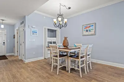 a dining room with a table and chairs at Treasure Island #0409 in Panama City Beach