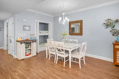 a dining room with a white table and chairs at Treasure Island #2109 in Panama City Beach