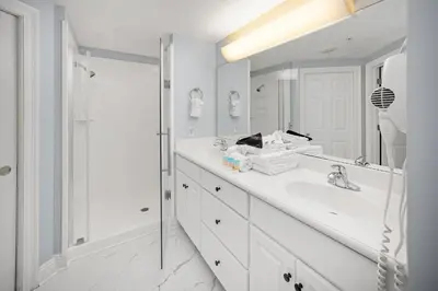 a white bathroom with a sink and a shower at Treasure Island #2109 in Panama City Beach