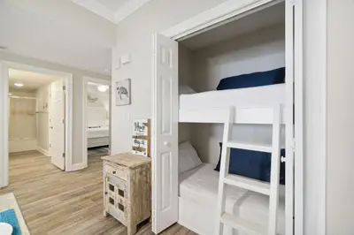 a bedroom with a bunk bed with a ladder at Treasure Island #2007 in Panama City Beach