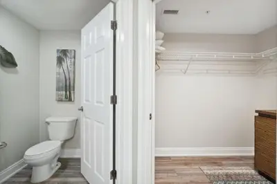 a bathroom with a toilet and a closet at Treasure Island #2007 in Panama City Beach