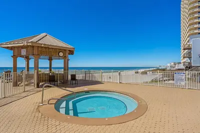 a hot tub with a gazebo next to the beach at Treasure Island #2007 in Panama City Beach