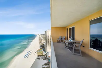 a balcony with a table and a view of the beach at Treasure Island #2007 in Panama City Beach