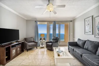 a living room with a couch and a flat screen tv at Treasure Island #1808 in Panama City Beach