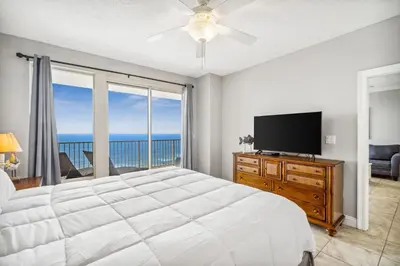 a bedroom with a large bed and a television at Treasure Island #1808 in Panama City Beach