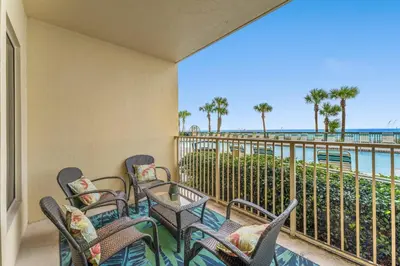a balcony with chairs and a view of the ocean at Gulf Crest #0106 in Panama City Beach