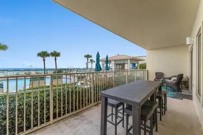 a balcony with a table and chairs and the ocean at Gulf Crest #0106 in Panama City Beach