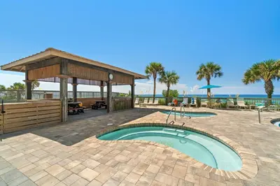a patio with a swimming pool and a pavilion at Gulf Crest #0106 in Panama City Beach