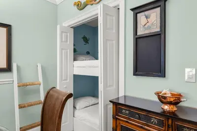 a room with a closet with a desk and a mirror at Treasure Island #1710 in Panama City Beach