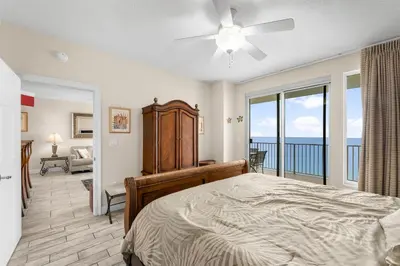 a bedroom with a bed and a view of the ocean at Treasure Island #1609 in Panama City Beach