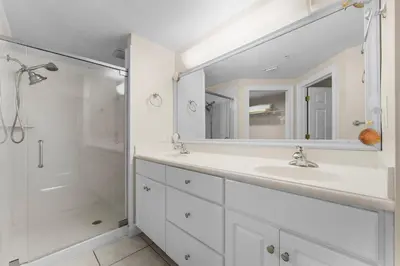 a white bathroom with a sink and a shower at Treasure Island #1609 in Panama City Beach