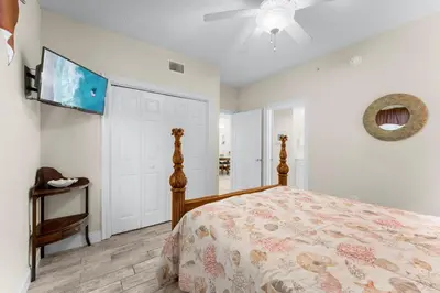 a bedroom with a bed and a ceiling fan at Treasure Island #1609 in Panama City Beach
