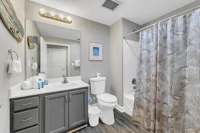 a bathroom with a sink and a toilet and a shower at Sterling Reef 1704 in Panama City Beach