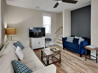 a living room with a white couch and a tv at Bungalows at Seagrove #149 - Three Little Birds Bungalow 30A in Seagrove Beach