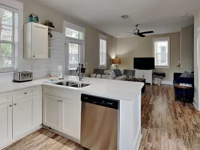 a kitchen with a sink and a living room at Bungalows at Seagrove #149 - Three Little Birds Bungalow 30A in Seagrove Beach