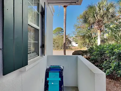 a suitcase is sitting outside of a house at Bungalows at Seagrove #149 - Three Little Birds Bungalow 30A in Seagrove Beach