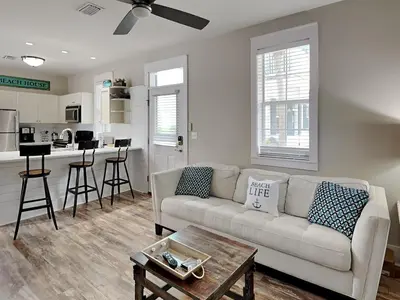 a living room with a couch and a table at Bungalows at Seagrove #149 - Three Little Birds Bungalow 30A in Seagrove Beach