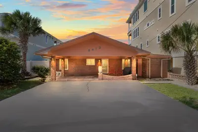 a building with a driveway in front of a building at GULF FRONT 3BD/2BA Home with private beach access! in Panama City Beach
