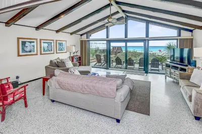 a living room with a couch and a television at GULF FRONT 3BD/2BA Home with private beach access! in Panama City Beach