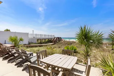 a picnic table and chairs on the beach at GULF FRONT 3BD/2BA Home with private beach access! in Panama City Beach