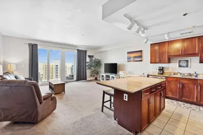 a kitchen and living room with a couch and a table at OCEAN VIEW 10th floor condo at the Laketown Wharf 1004 in Panama City Beach