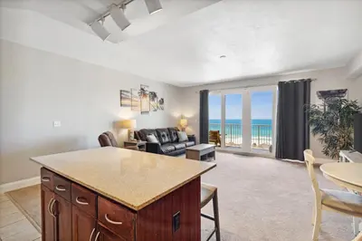 a kitchen and living room with a view of the ocean at OCEAN VIEW 10th floor condo at the Laketown Wharf 1004 in Panama City Beach