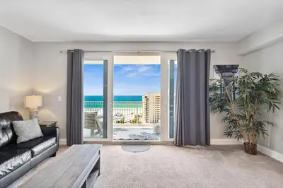 a living room with a couch and a large window at OCEAN VIEW 10th floor condo at the Laketown Wharf 1004 in Panama City Beach