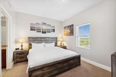 a bedroom with a bed and two night stands at OCEAN VIEW 10th floor condo at the Laketown Wharf 1004 in Panama City Beach