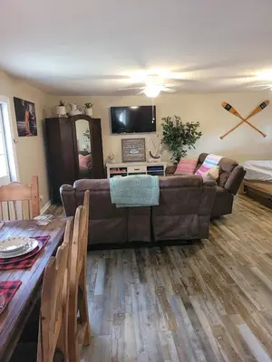 a living room with a couch and a table at Historic GWALTNEY HOUSE-Cottage at St Andrew's Bay in Panama City