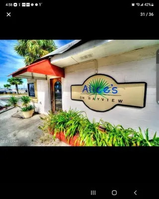 a restaurant with a sign on the side of a building at Historic GWALTNEY HOUSE-Cottage at St Andrew's Bay in Panama City