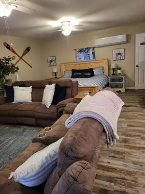 a living room with a couch and a bed at Historic GWALTNEY HOUSE-Cottage at St Andrew's Bay in Panama City