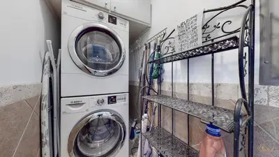 a laundry room with a washer and dryer at Huge Balcony - Beachfront - Renovated - FLPCB87 in Panama City Beach