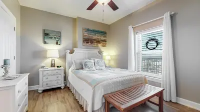 a bedroom with a bed and a window at Huge Balcony - Beachfront - Renovated - FLPCB87 in Panama City Beach